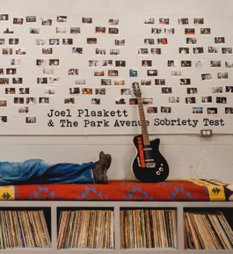 Album cover "Joel Plaskett & The Park Avenue Sobriety Test" featuring Joel's legs in jeans lying on a bench with LPs underneath and polaroids above